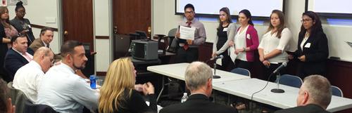 William Cullen Bryant HS students answer judges' questions after presenting their debate topic arguments. 